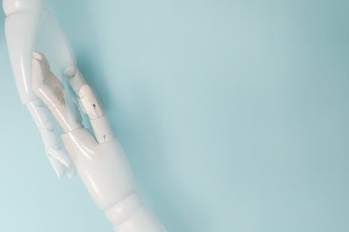 White Robot Hand in Close Up Photography