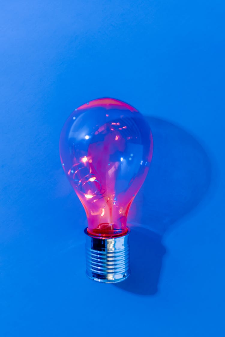 Light Bulb On Blue Surface