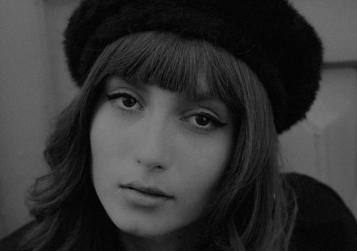 Free Close-up monochrome portrait of a woman wearing a beret, looking expressive. Stock Photo