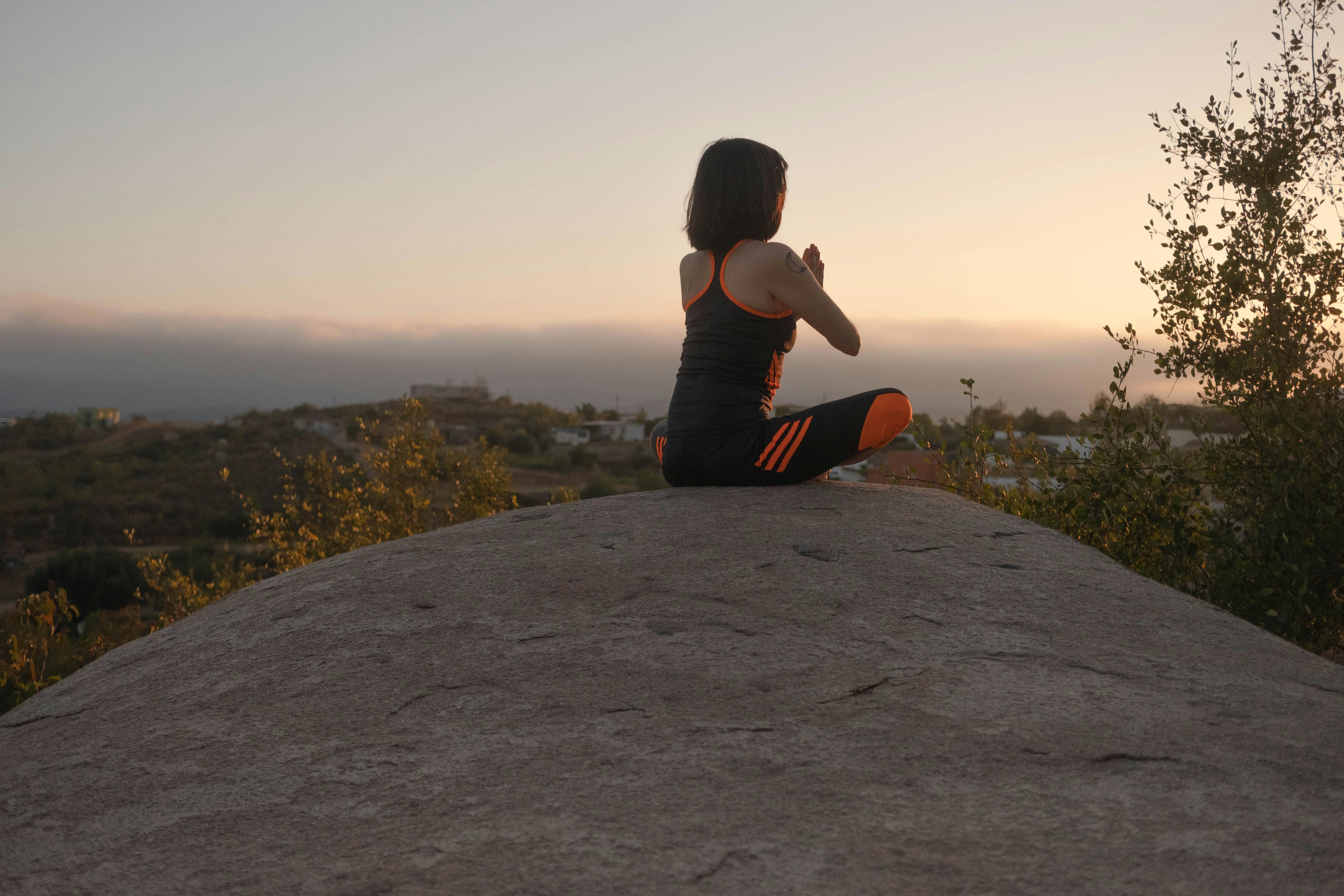 Person meditating in a serene outdoor setting - what is emdr primarily used for