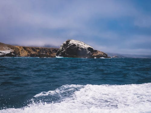 Brown Rock Formation Near the Blue Sea 