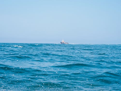 Fishing Boat Sails in an Ocean