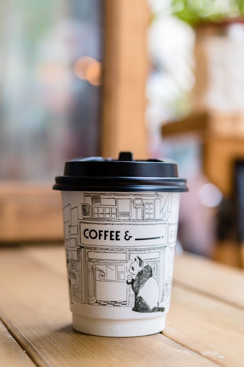 Free Panda Printed Paper Coffee Cup on Table Stock Photo