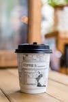 Free Panda Printed Paper Coffee Cup on Table Stock Photo