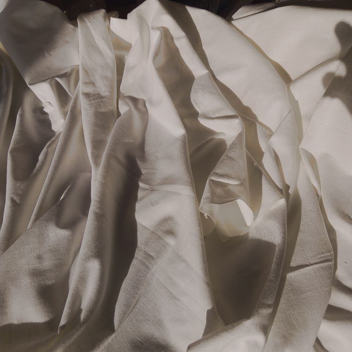 Rumpled stonewashed linen bedding in daylight — photo by Varvara Galvas on Pexels