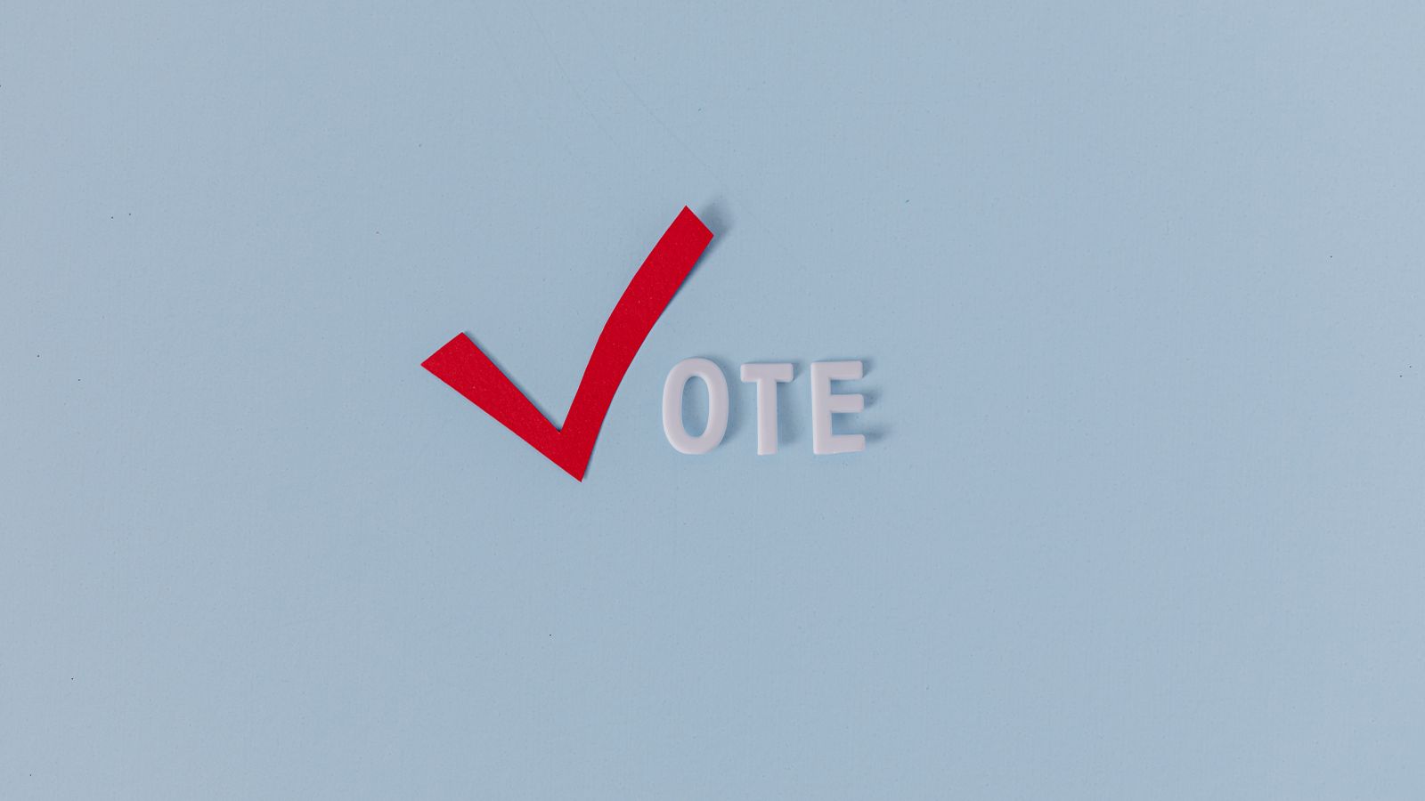 Red check mark with the word "VOTE" on a blue background, symbolizing election participation.
