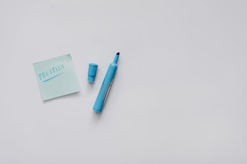 Blue Pen Beside Blue Sticky Note