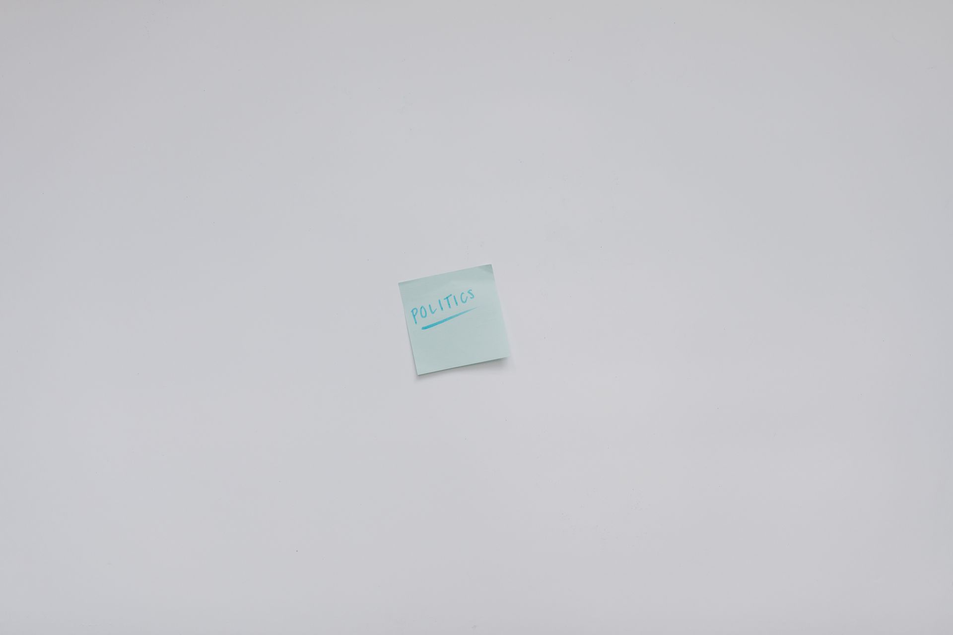 Simple top view of a note with the word 'Politics' on a white background.