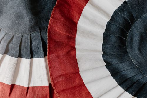 Free A close-up shot of red, white, and blue pleated fabric, symbolizing patriotism. Stock Photo
