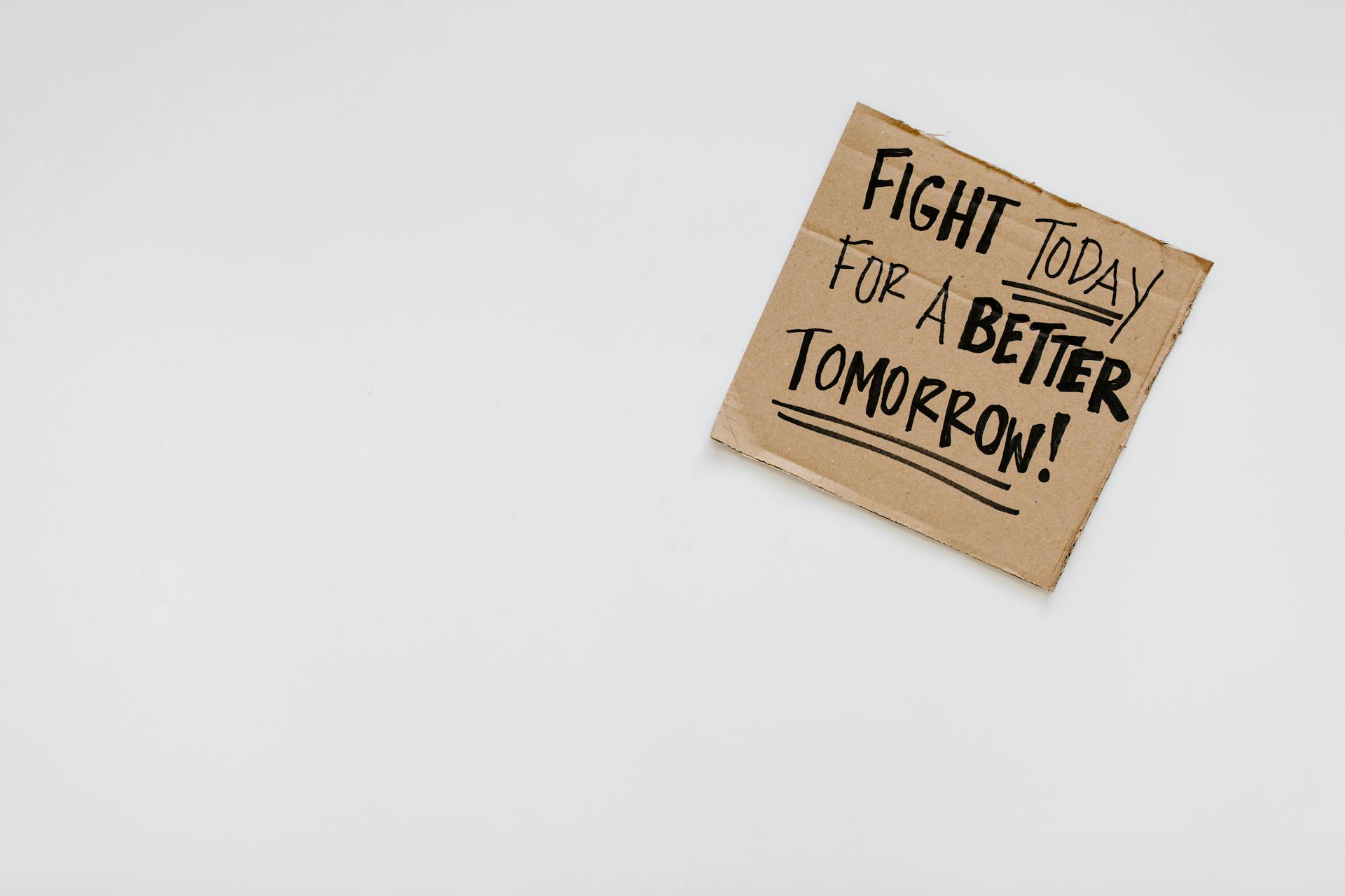 Handwritten motivational message on cardboard for a better future.