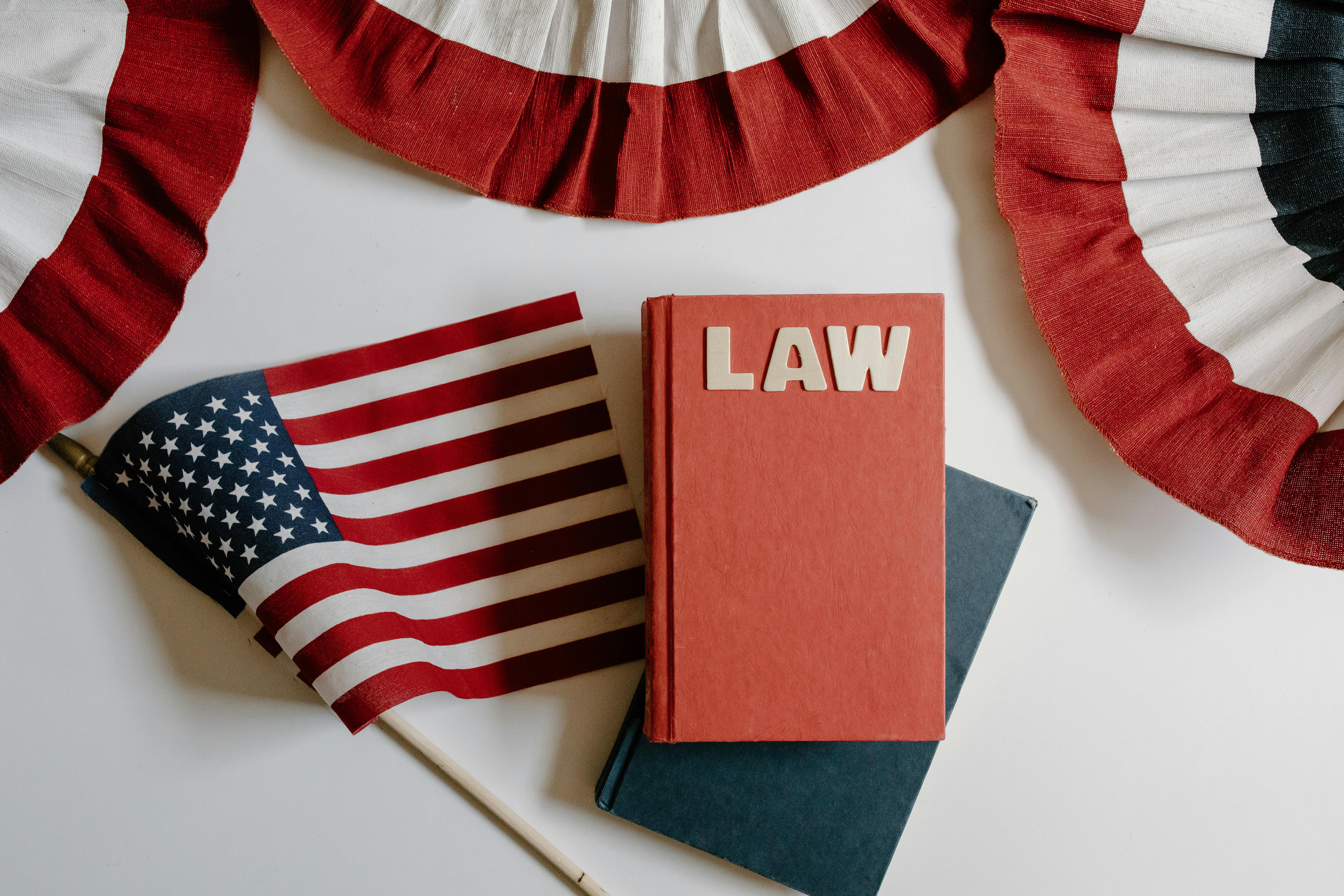 red and blue notebook beside american flag