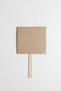 Brown Cardboard Box on White Stick