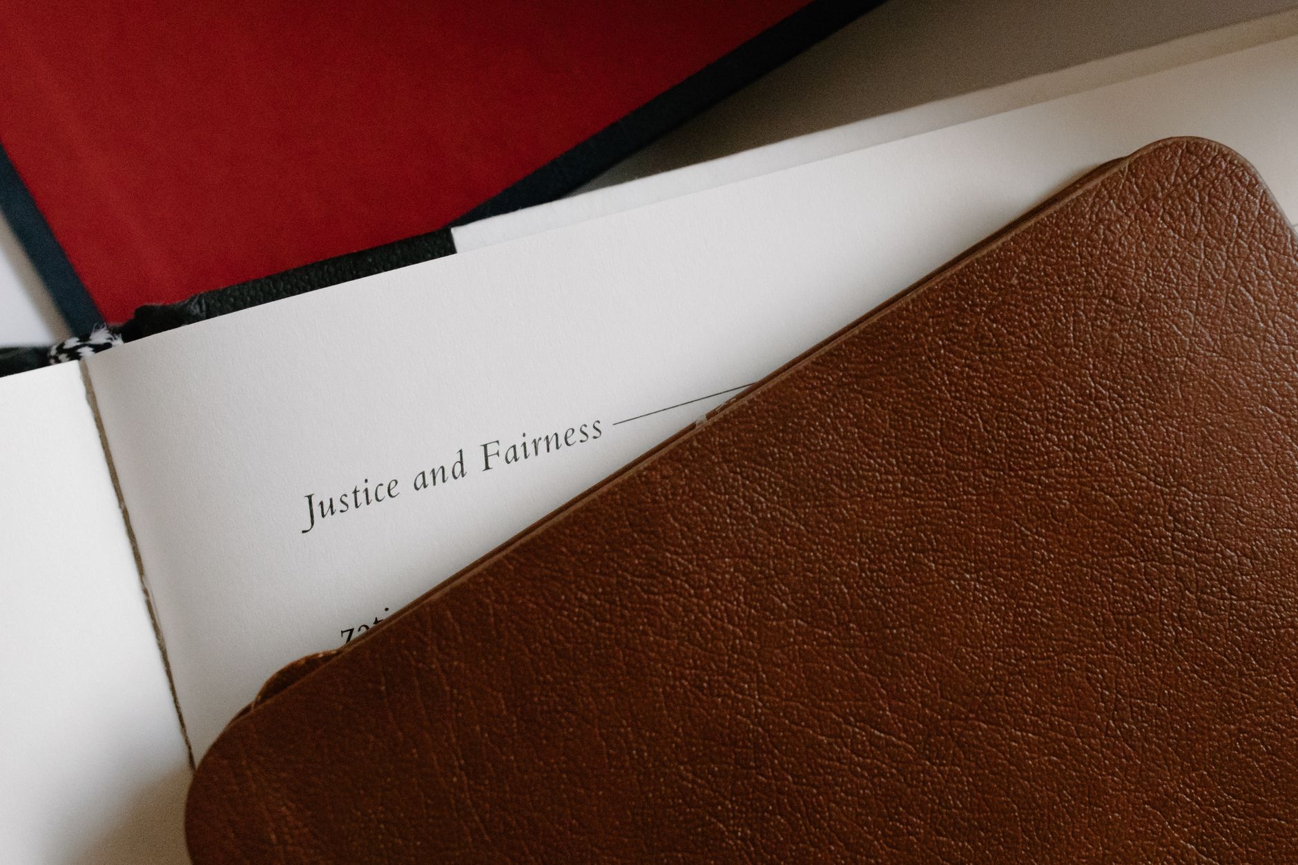 Leather-bound journal and open page titled 'Justice and Fairness'.