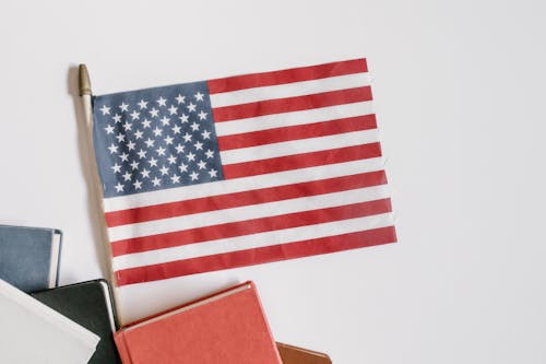 American Flag and Books on White Background