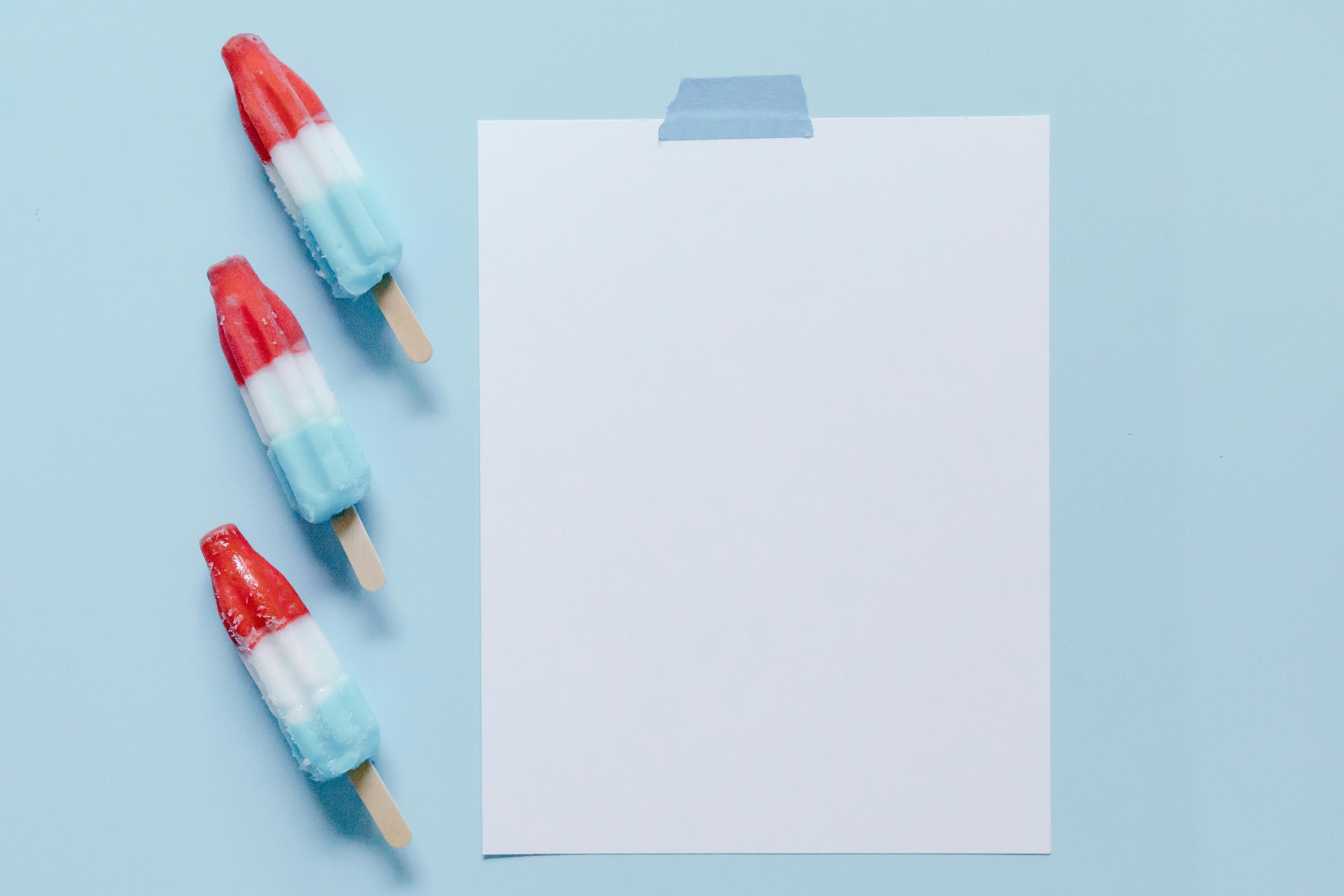 popsicles beside a blank piece of paper