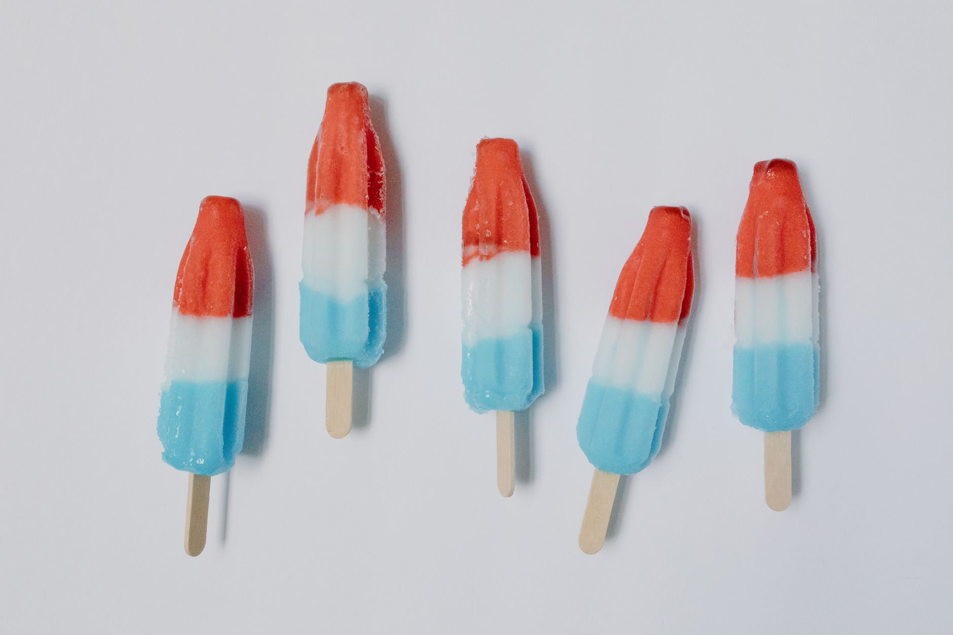 Colorful layers of Jell-O rocket pops cooling in molds