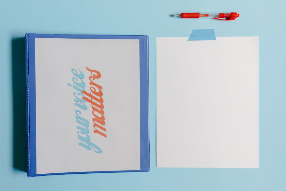 Your Voice Matters binder with blank paper and pen on blue background.