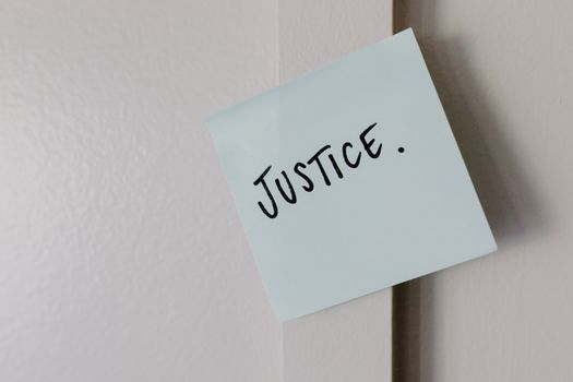 The Word Justice Written on Paper