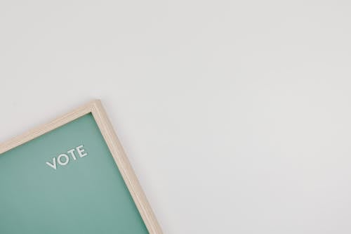 Letters on a Green Background with Wooden Frame on a White Surface