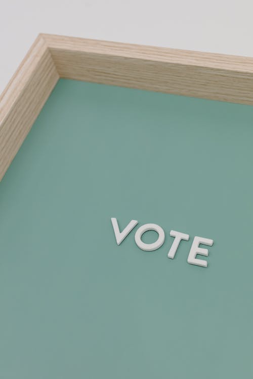 Free The Word Vote on Wooden Frame Stock Photo