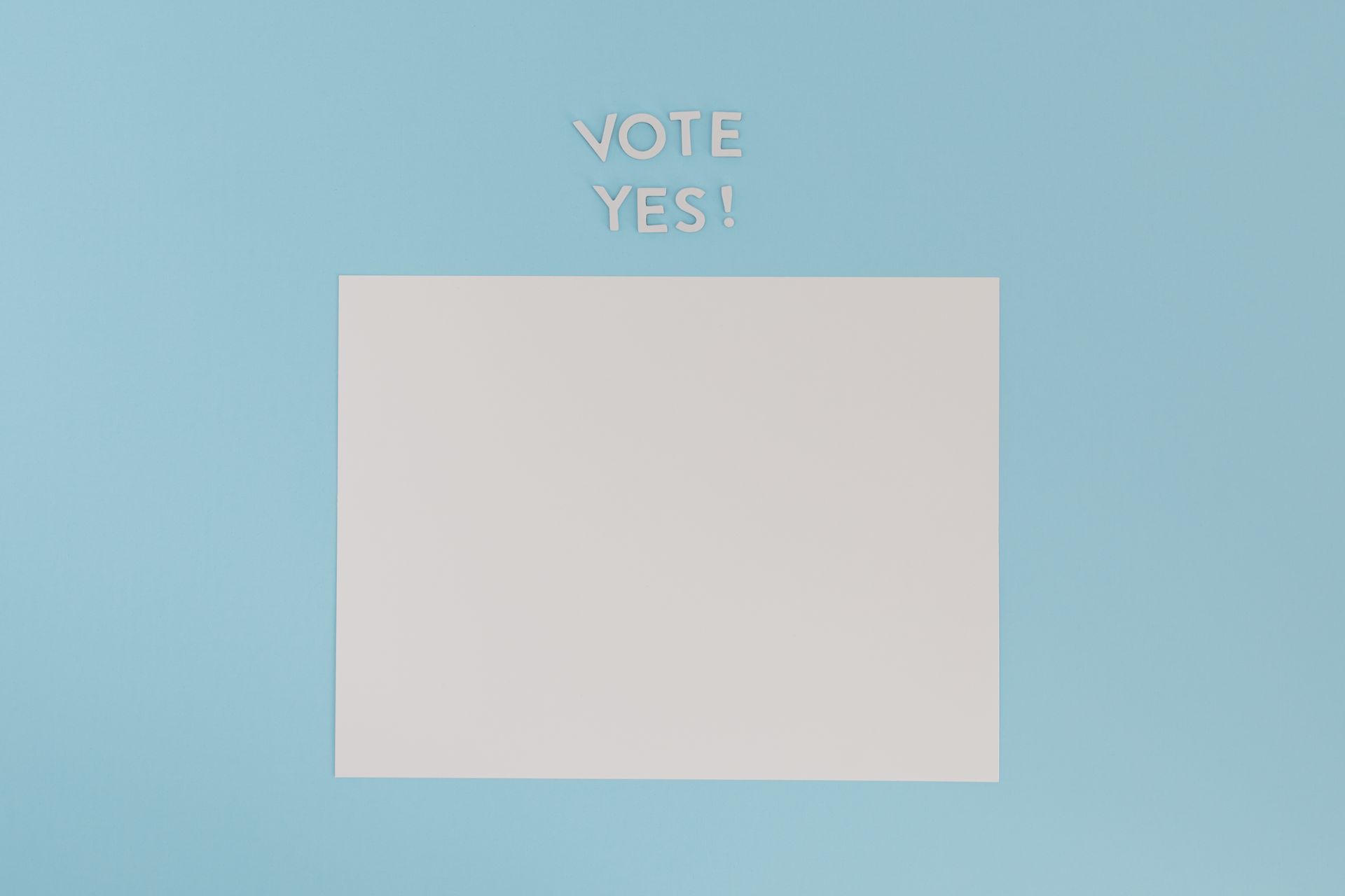 A Blank White Paper with a Vote Yes Text on a Blue Background
