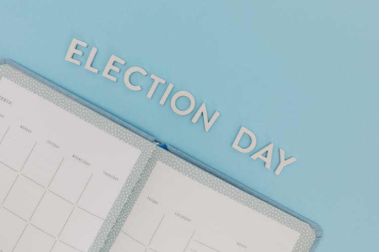 Election Day Words  And A Planner On A Blue Background