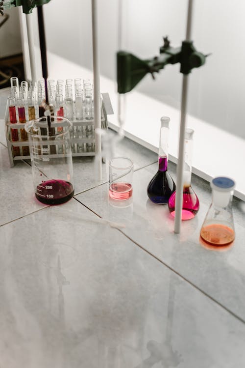 Clear Glass Bottles on Marble Surface