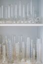 Clear Glass Cups on White Wooden Shelf