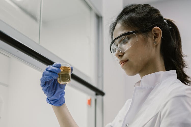 Woman Holding A Beaker With Liquid