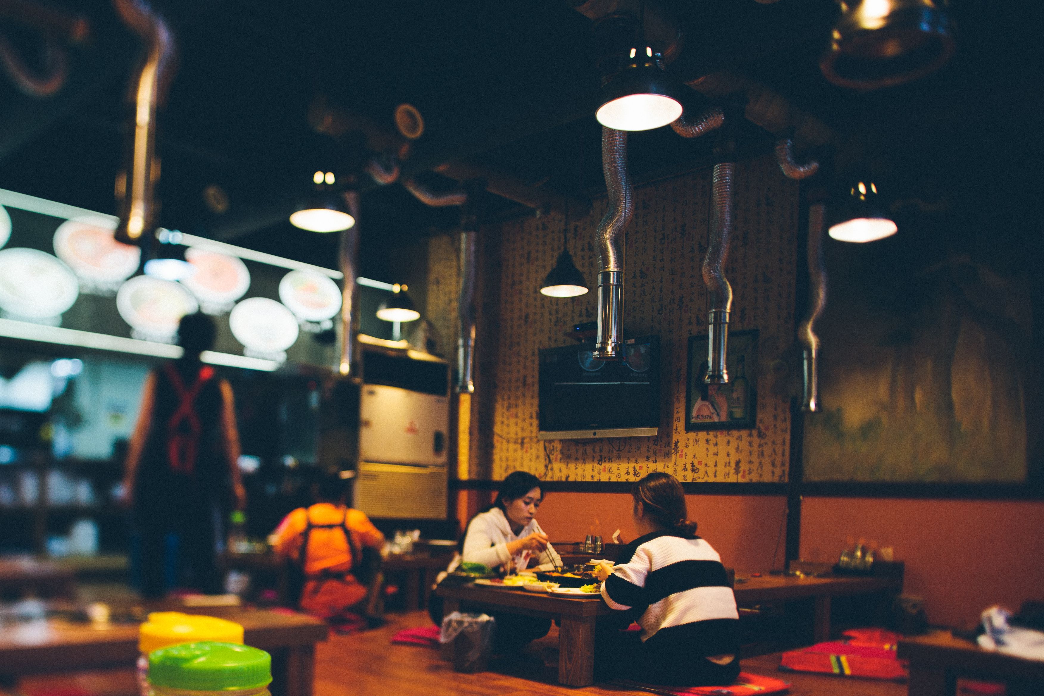 Intimate dining experience in a Korean restaurant with warm lighting and traditional decor.