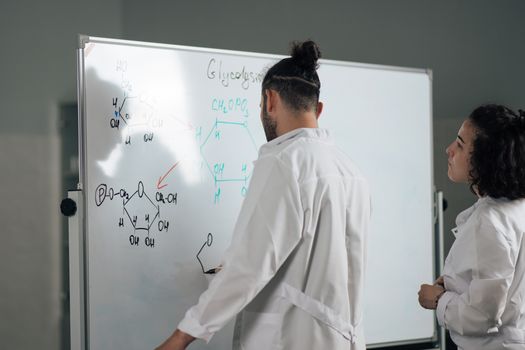 Man and Woman at Whiteboard