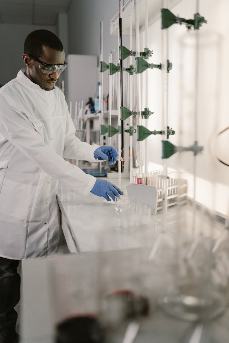 Man In White Laboratory Gown Wearing Black Framed Eyeglasses