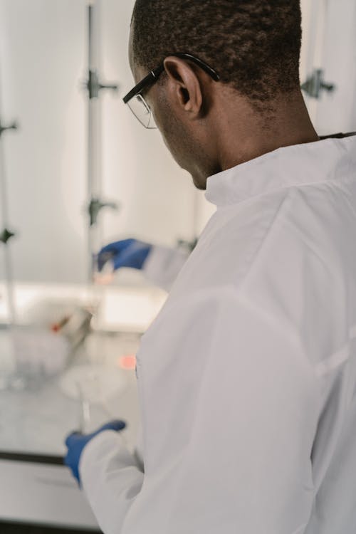 Man in a Lab Coat Doing Research in a Laboratory 