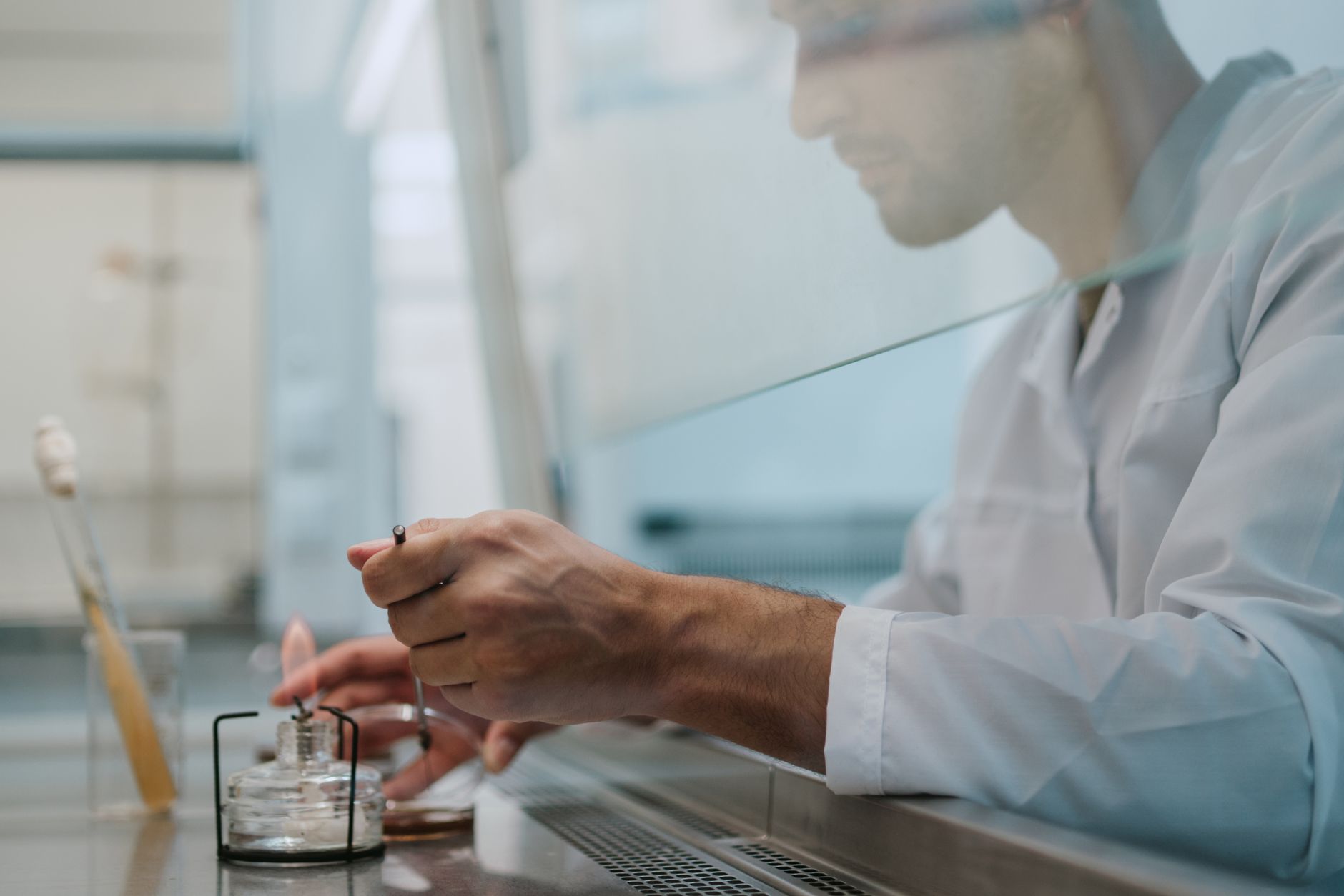 A scientist conducting an experiment in a lab, focusing on precision and safety.
