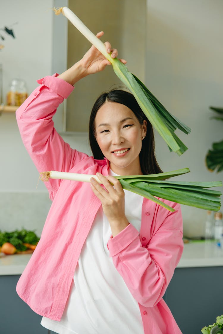 Woman Smiling While Holding Vegetables