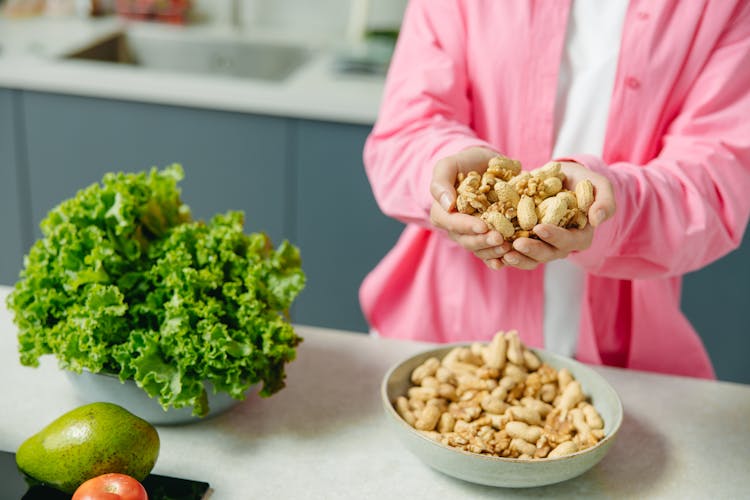 Woman's Hands Full Of Peanuts