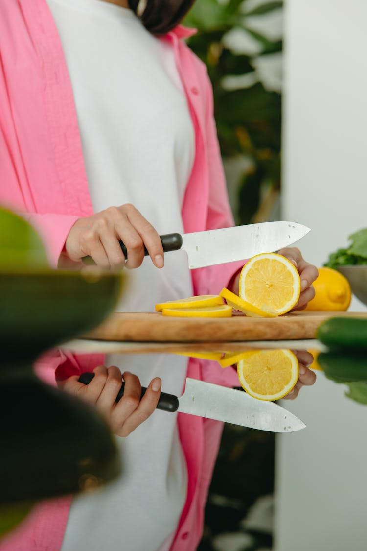 Close Up Photo Of Person Slicing Lemon