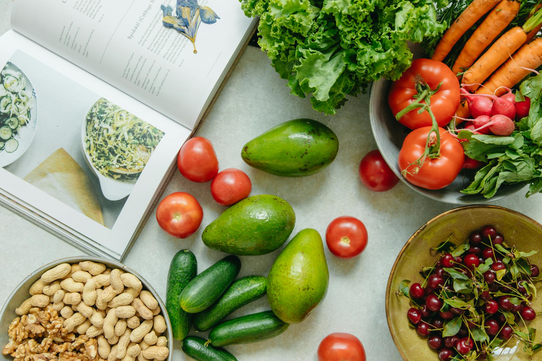 Top View of a Cookbook and Variety of Healthy Foods on a Table