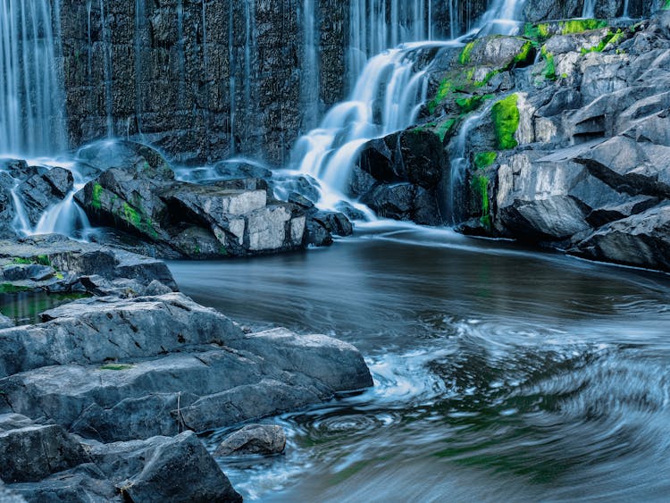 Water From Waterfall Pooling Between Rocks 