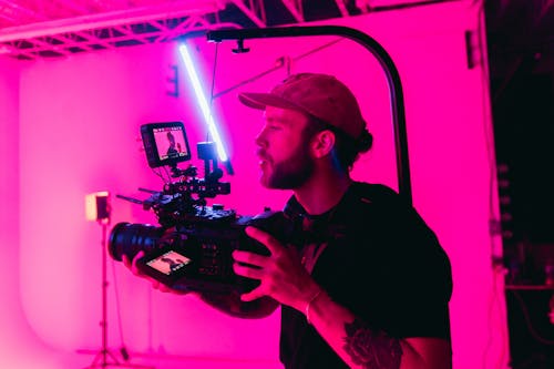 Man in Black Shirt Holding Black Video Camera