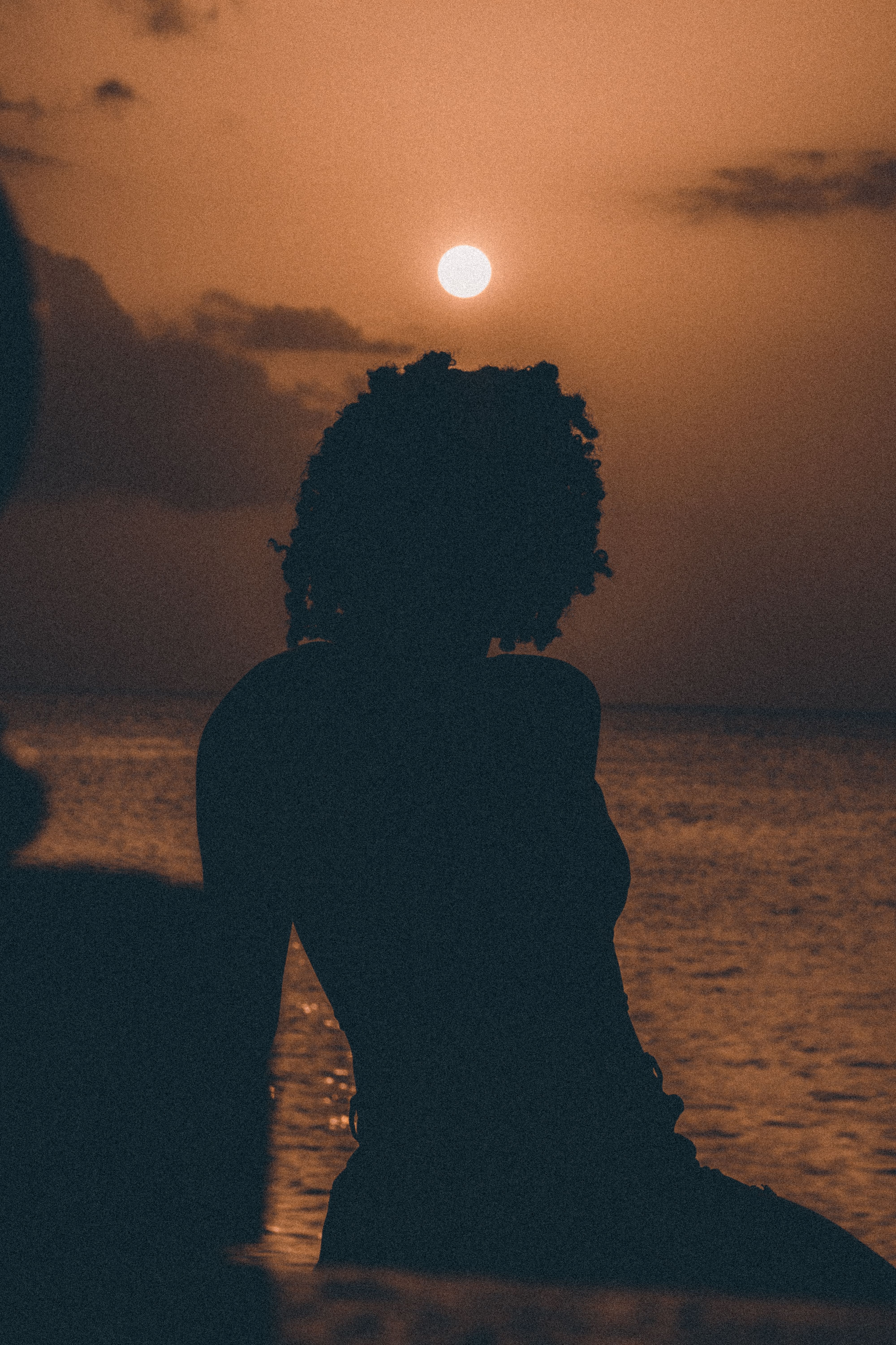 Silhouette of a Woman on the Beach at Sunset · Free Stock Photo