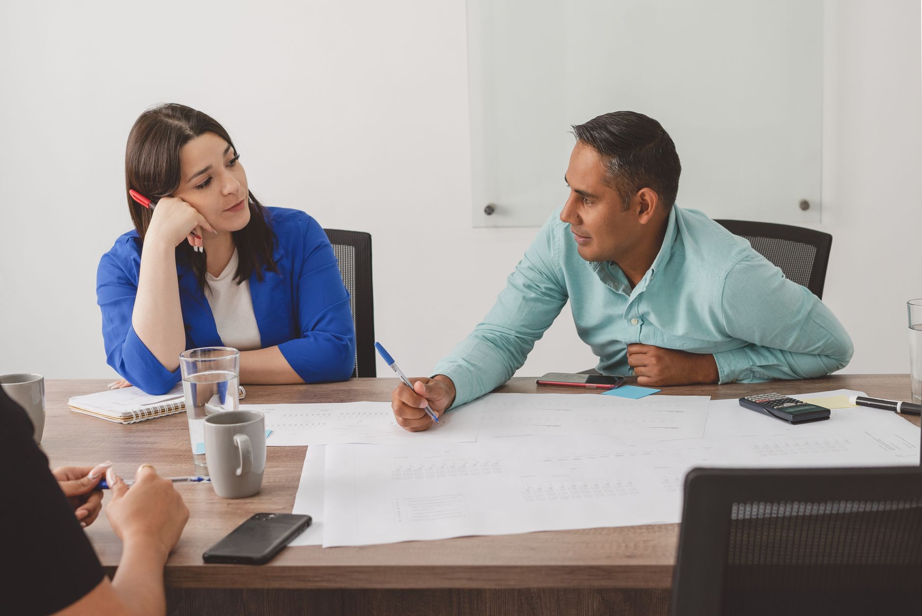 Business professionals engaging in a productive meeting at a modern office workspace.