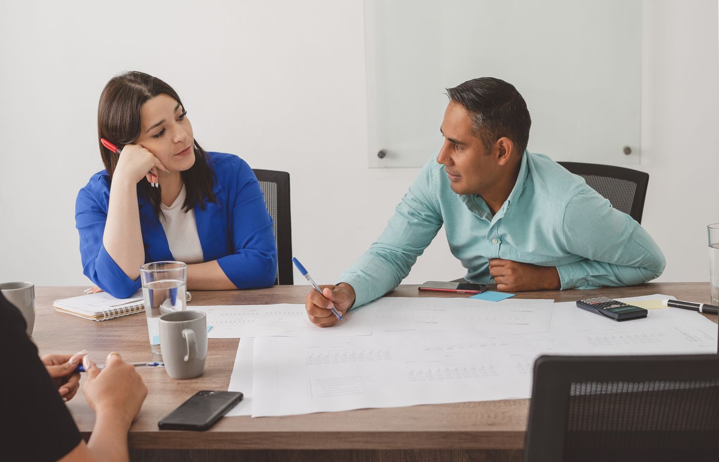 Business professionals engaging in a productive meeting at a modern office workspace.