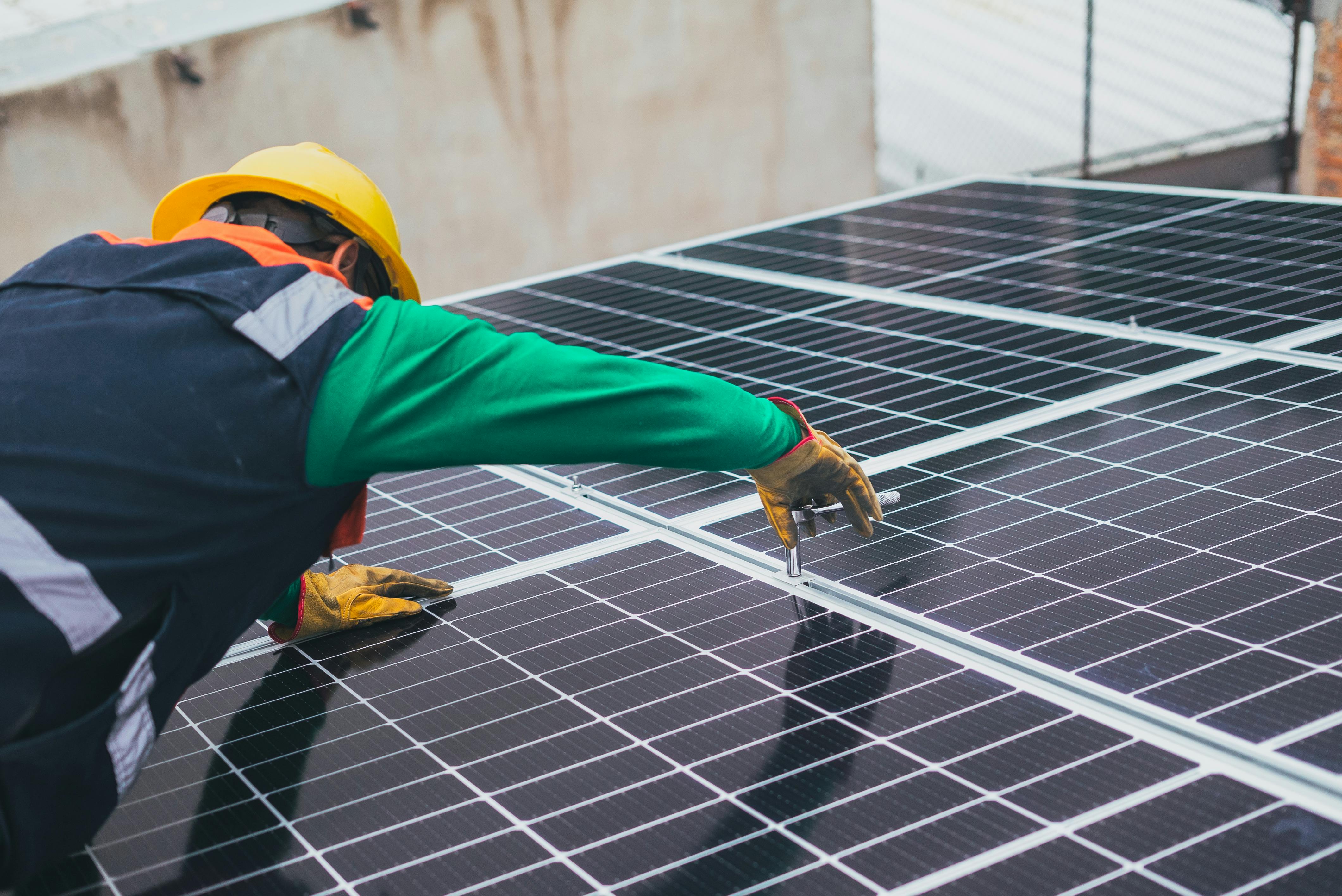 Solar Technician Installing Solar Panel · Free Stock Photo