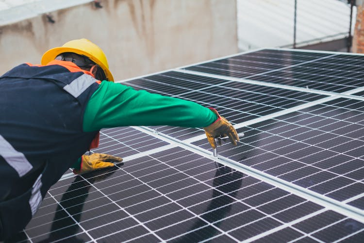 Solar Technician Installing Solar Panel