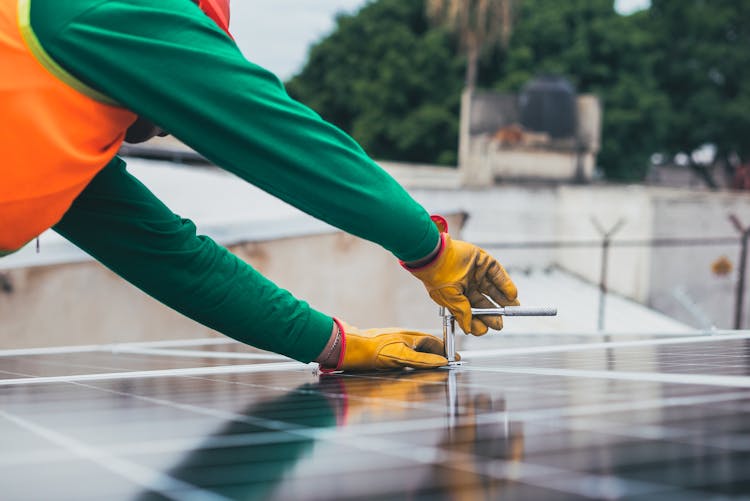 Solar Technician Installing Solar Panel