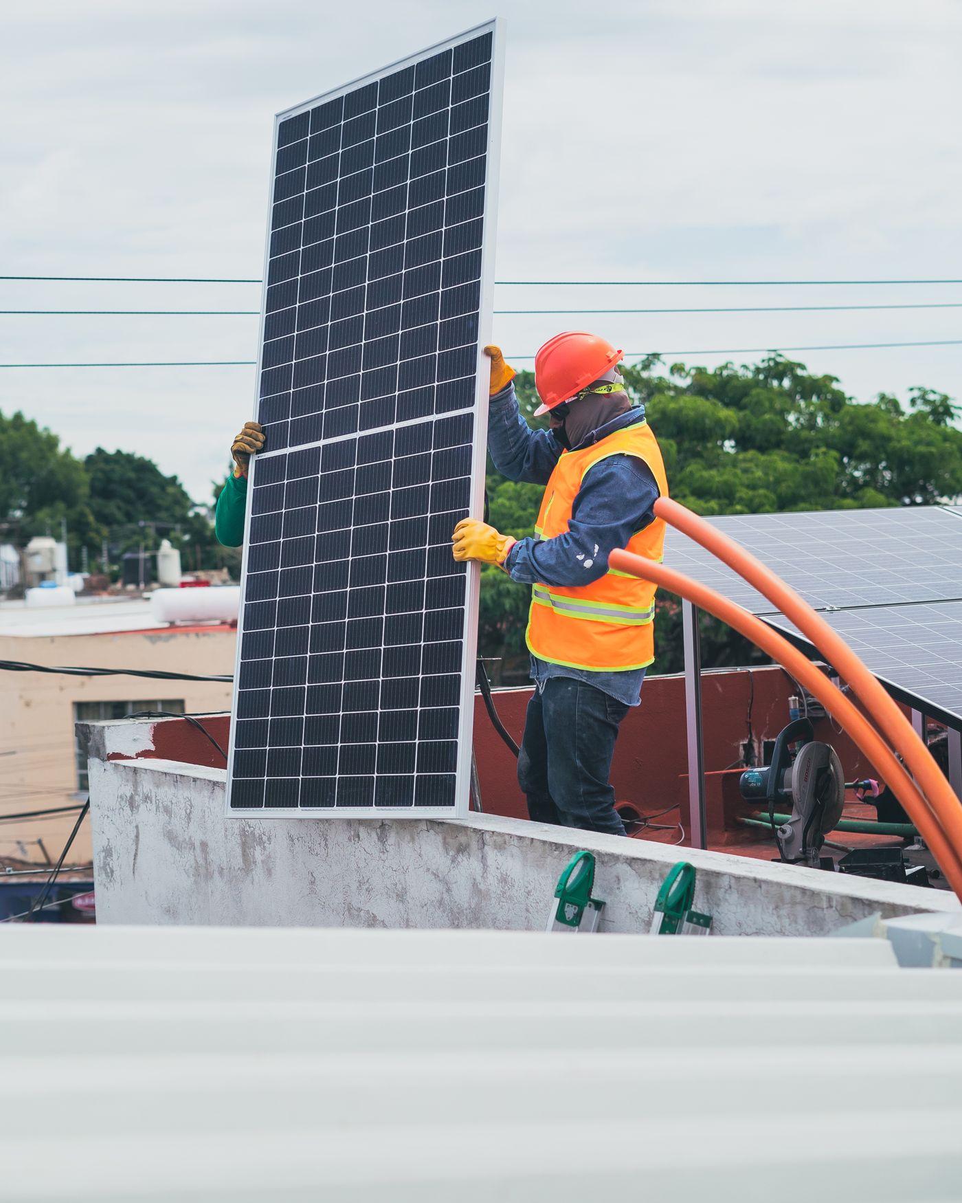 Installers fitting solar panels on a rooftop