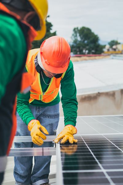 Solar technician installing a commercial rooftop solar array