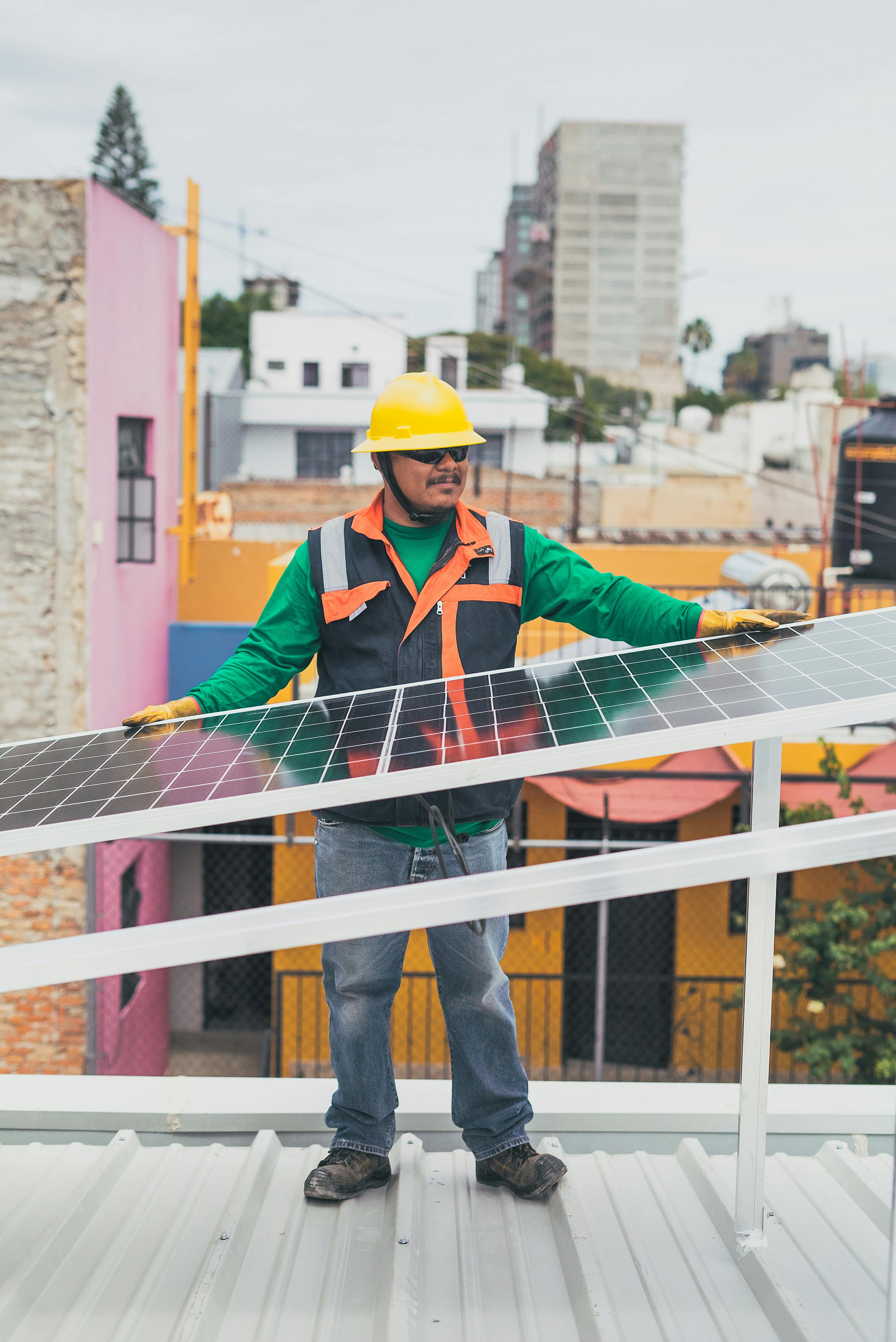 solar technician leaning on solar panel