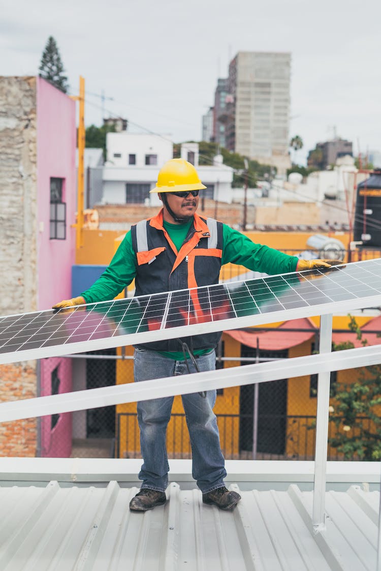 Solar Technician Leaning On Solar Panel